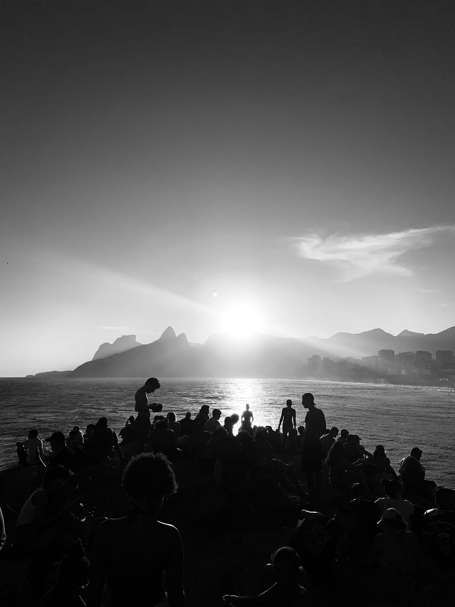 A stadium crowd of thousands, with one person lit and in focus